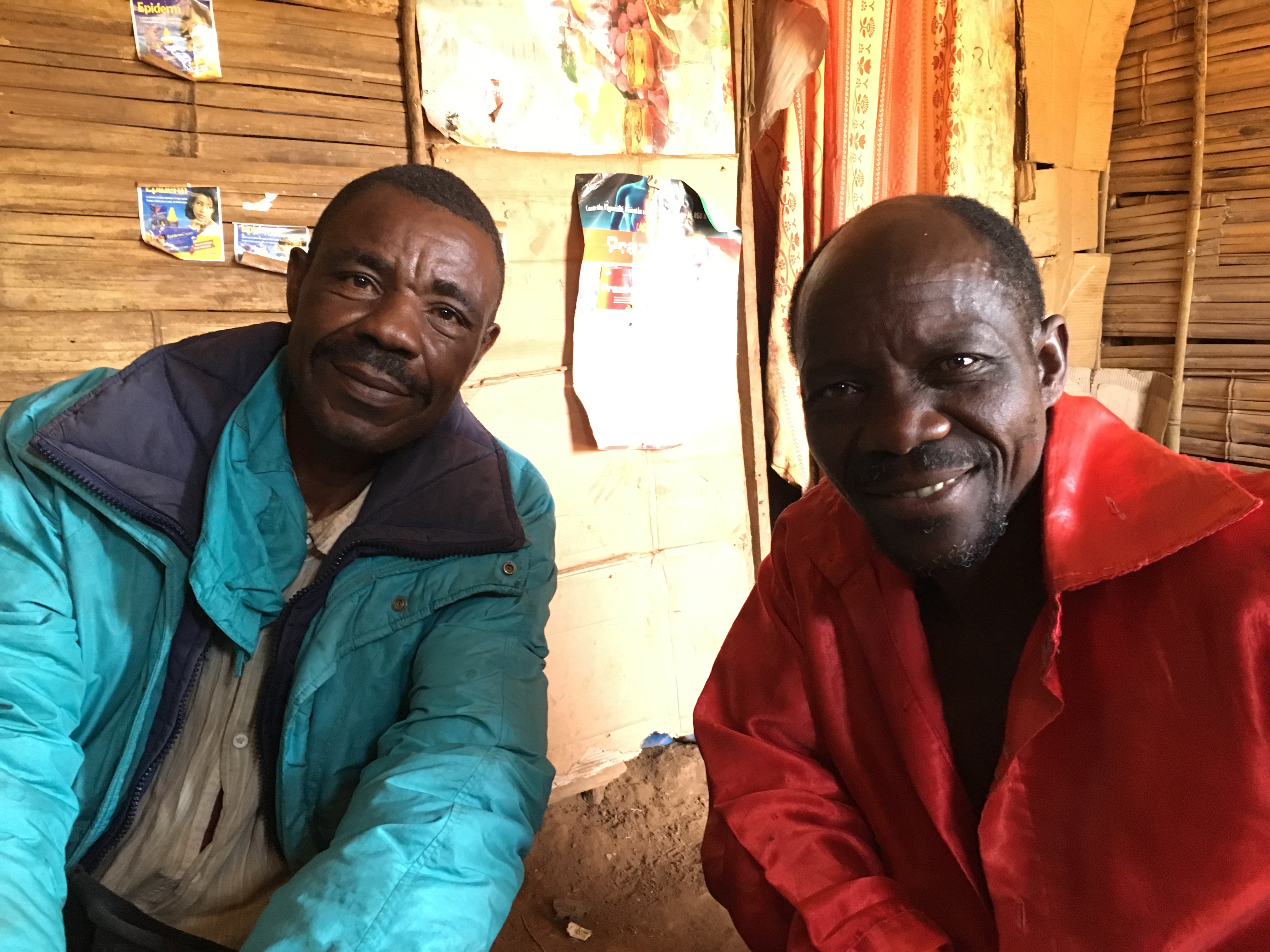 Francis (left) and Miti sit in Francis's home in Karambi, eastern Congo
